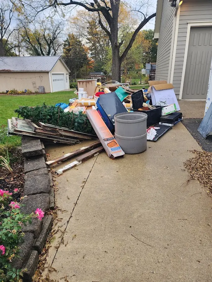 Dumpster being loaded with debris for Roofing Dumpster Rental in Raeford
